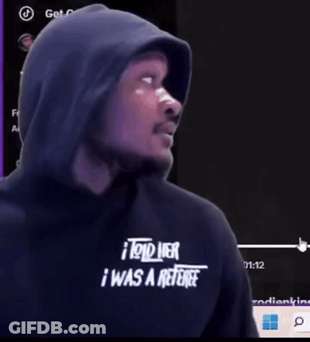 A Man Wearing A Hooded Sweatshirt That Says I Told Her I Was A Referee GIF