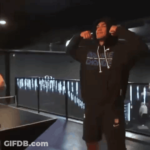 A Man Wearing A Hooded Sweatshirt With A Nike Logo On It GIF