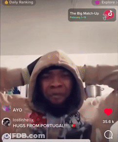 A Man Wearing A Hooded Sweatshirt With His Arms Outstretched In Front Of A Screen That Says Daily Ranking On It GIF