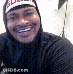 A Man Wearing A Hoodie And A Hat With The Word Elite On It Smiles For The Camera GIF