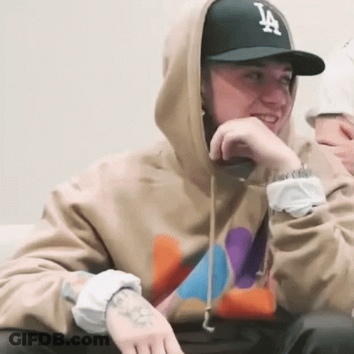 A Man Wearing A Hoodie And A La Hat GIF