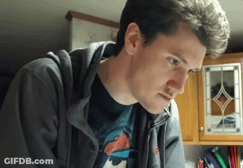 A Man Wearing A Hoodie And A T-Shirt With The Letter M On The Sleeve GIF