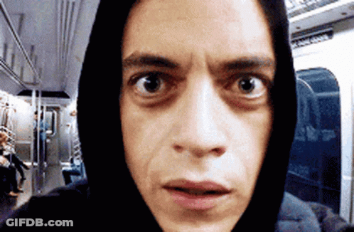 A Man Wearing A Hoodie Is Taking A Selfie On A Train GIF