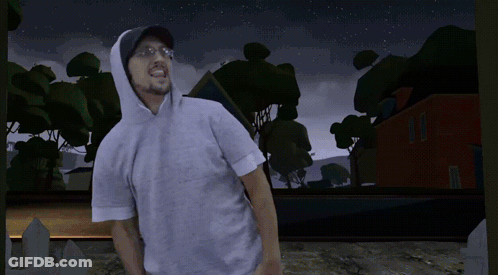 A Man Wearing A Hoodie Stands In Front Of A Cemetery At Night GIF