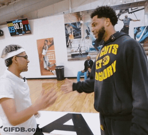 A Man Wearing A Hoodie That Says Cuts Glory Shakes Hands With Another Man GIF