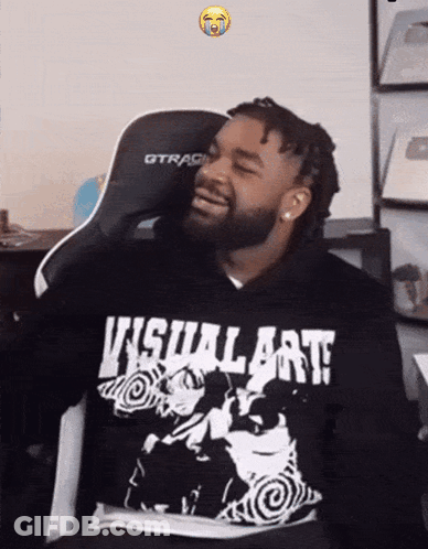 A Man Wearing A Hoodie That Says Visual Art Is Smiling GIF