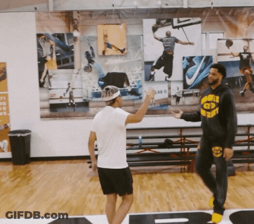 A Man Wearing A Hoodie That Says Warriors On It Talks To Another Man GIF