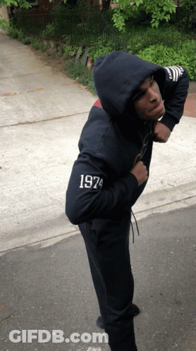A Man Wearing A Hoodie With 1974 On The Sleeve GIF