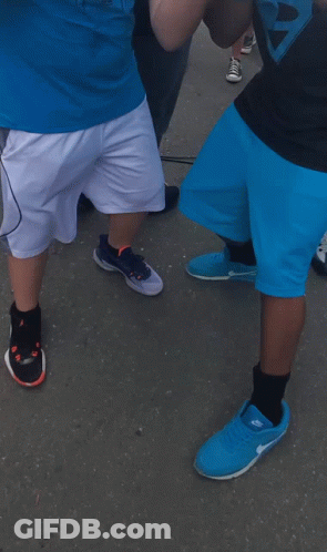 A Man Wearing A Horn Jersey Stands Next To Another Man GIF