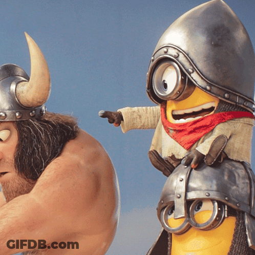 A Man Wearing A Horned Helmet Stands Next To A Yellow Minion GIF
