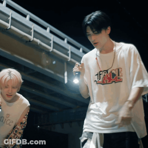 A Man Wearing A Jack T-Shirt Holds A Flashlight In His Hand GIF