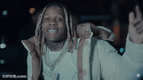 A Man Wearing A Jacket And A Necklace With A Pendant That Says ' Grungy ' On It GIF
