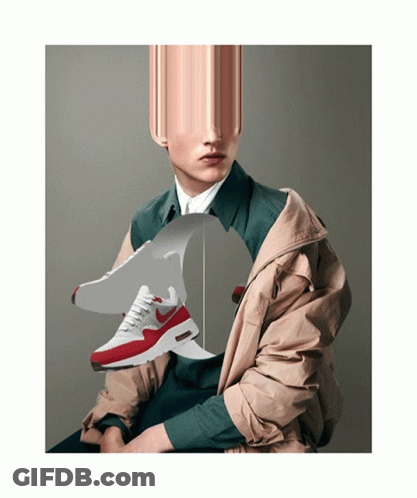 A Man Wearing A Jacket Is Holding A Pair Of Nike Shoes GIF