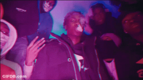 A Man Wearing A Jacket That Says Essentials On It GIF