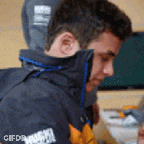 A Man Wearing A Jacket That Says Husky On The Sleeves GIF