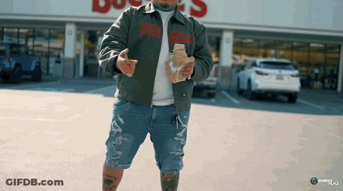 A Man Wearing A Jacket That Says " That 'S A Lot Of Money " On It GIF