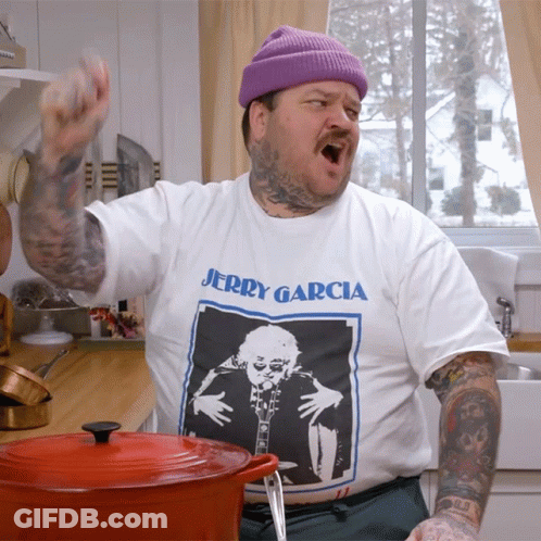 A Man Wearing A Jerry Garcia T-Shirt Is Standing In A Kitchen GIF