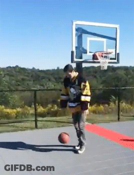 A Man Wearing A Jersey That Says ' Boston Bruins ' On It Is Playing Basketball GIF
