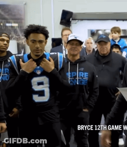 A Man Wearing A Jersey With The Number 9 On It Stands In A Crowd GIF