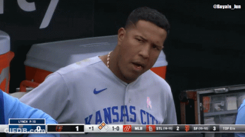 A Man Wearing A Kansas City Jersey Stands In A Dugout GIF