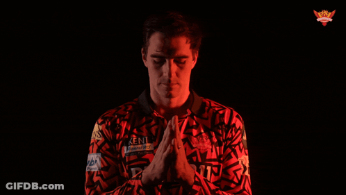 A Man Wearing A Kent Shirt With His Hands Folded GIF