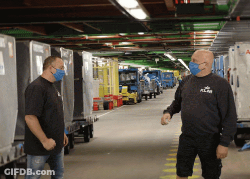 A Man Wearing A Klm Shirt Stands In A Warehouse GIF