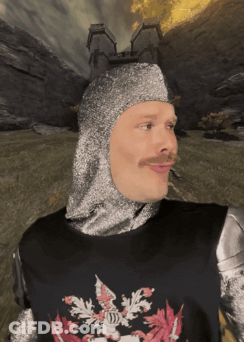 A Man Wearing A Knight 'S Helmet And Armor With A Crest On His Chest GIF