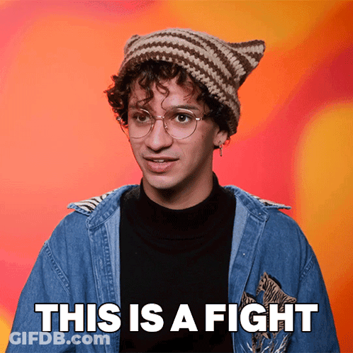 A Man Wearing A Knitted Hat And Glasses Says This Is A Fight GIF