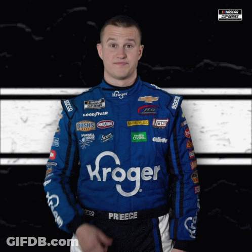 A Man Wearing A Kroger Racing Suit Looks At The Camera GIF