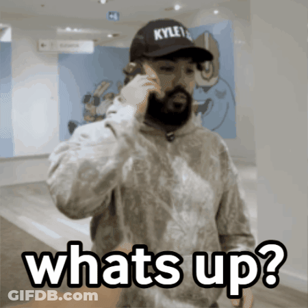 A Man Wearing A Kyle 'S Hat Is Talking On A Cell Phone And Says Whats Up GIF