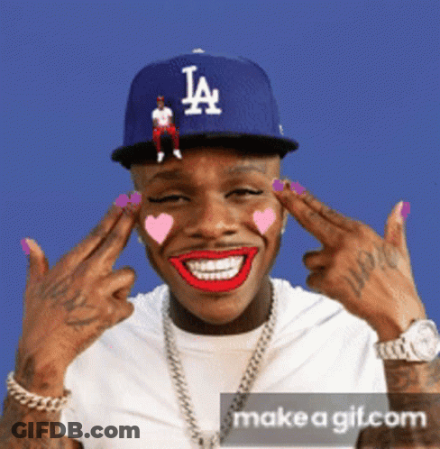 A Man Wearing A La Hat Is Making A Face GIF