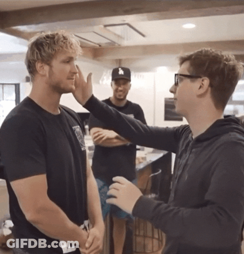 A Man Wearing A La Hat Talks To Another Man In A Kitchen GIF