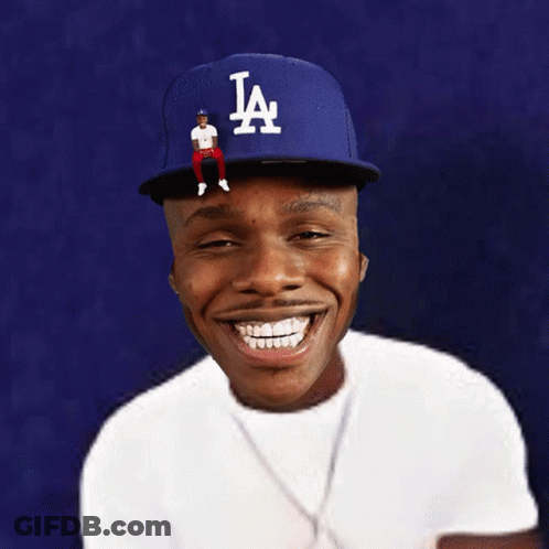 A Man Wearing A La Hat With A Man Sitting On Top GIF