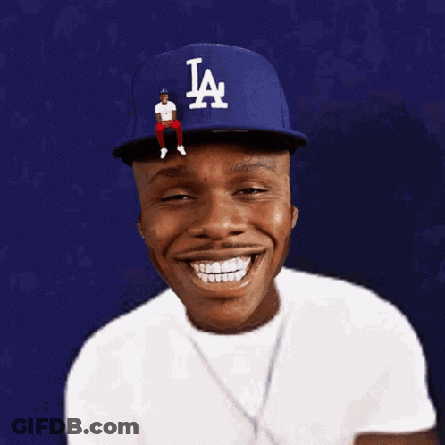A Man Wearing A La Hat With A Man Sitting On Top GIF