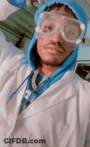 A Man Wearing A Lab Coat And Goggles Is Taking A Picture GIF