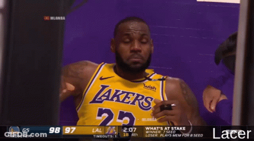 A Man Wearing A Lakers Jersey Looks At Something GIF