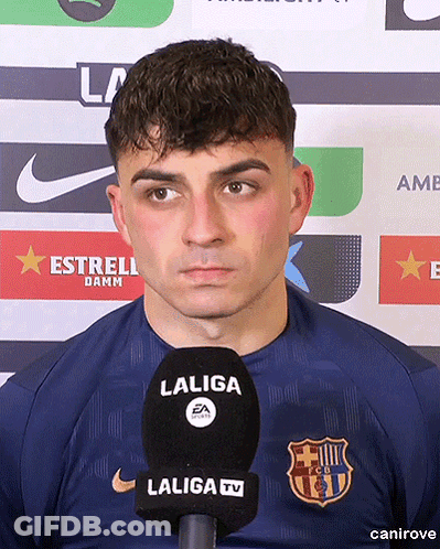 A Man Wearing A Laliga Shirt Stands In Front Of A Laliga Tv Microphone GIF