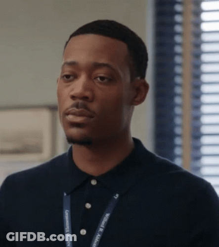 A Man Wearing A Lanyard That Says Community Recovery On It GIF