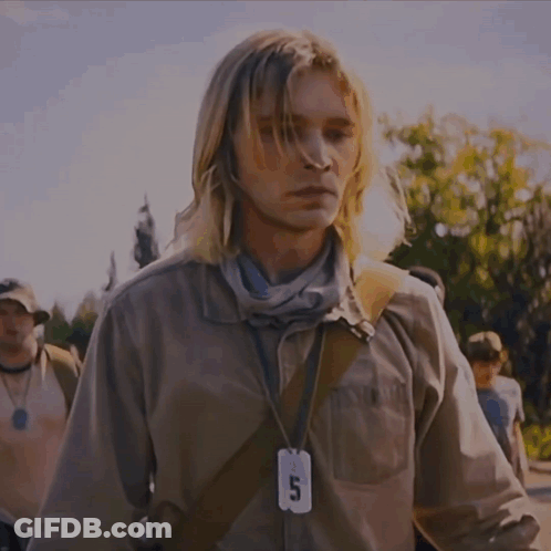 A Man Wearing A Lanyard With A Tag That Says 5 On It GIF