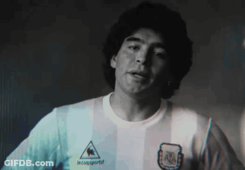 A Man Wearing A Le Coq Sportif Shirt Is Looking At The Camera GIF