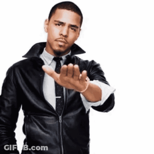 A Man Wearing A Leather Jacket And Tie Is Making A Stop Gesture GIF