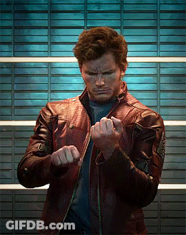 A Man Wearing A Leather Jacket Is Making A Fist GIF