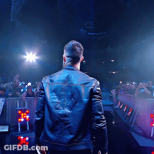 A Man Wearing A Leather Jacket With A X On The Back GIF