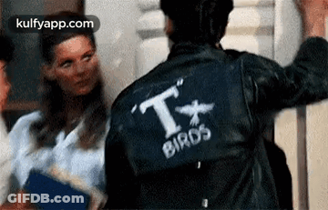 A Man Wearing A Leather Jacket With The Word Birds On It . GIF