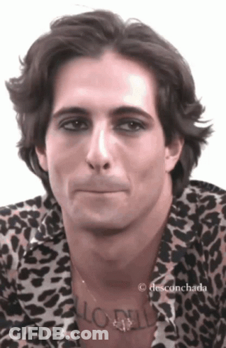 A Man Wearing A Leopard Print Shirt Has A Tattoo On His Neck That Says ' Aloha ' GIF