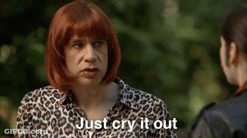 A Man Wearing A Leopard Print Shirt Is Talking To A Woman . GIF