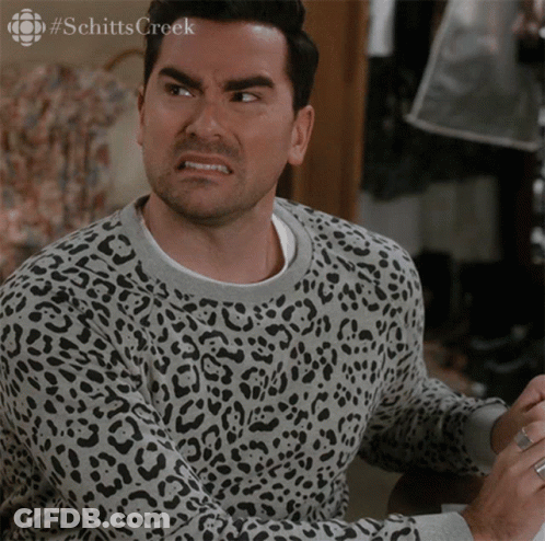 A Man Wearing A Leopard Print Sweater Has The Word Schitts Creek On The Bottom Left GIF