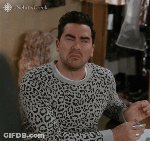 A Man Wearing A Leopard Print Sweater With #Schitts Creek Written On The Bottom GIF