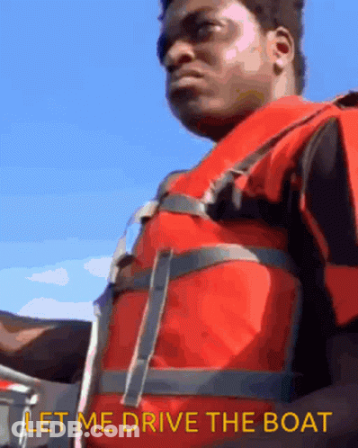 A Man Wearing A Life Vest Says Let Me Drive The Boat GIF