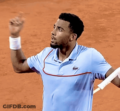 A Man Wearing A Light Blue Shirt With A Lacoste Logo On The Front GIF